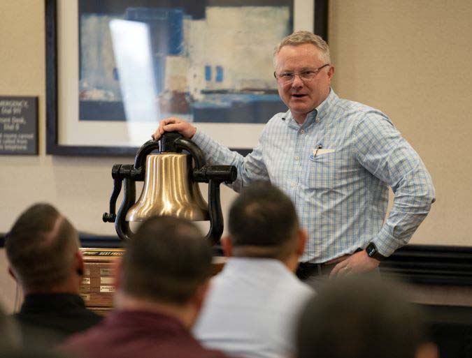 Executive Vice President and Chief Operations Officer Matt Igoe at a bell presentation. 